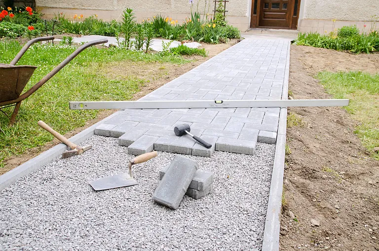 Paving path being laid in a garden