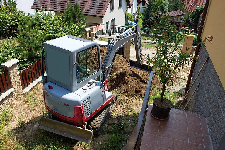 A mini digger in a customers garden